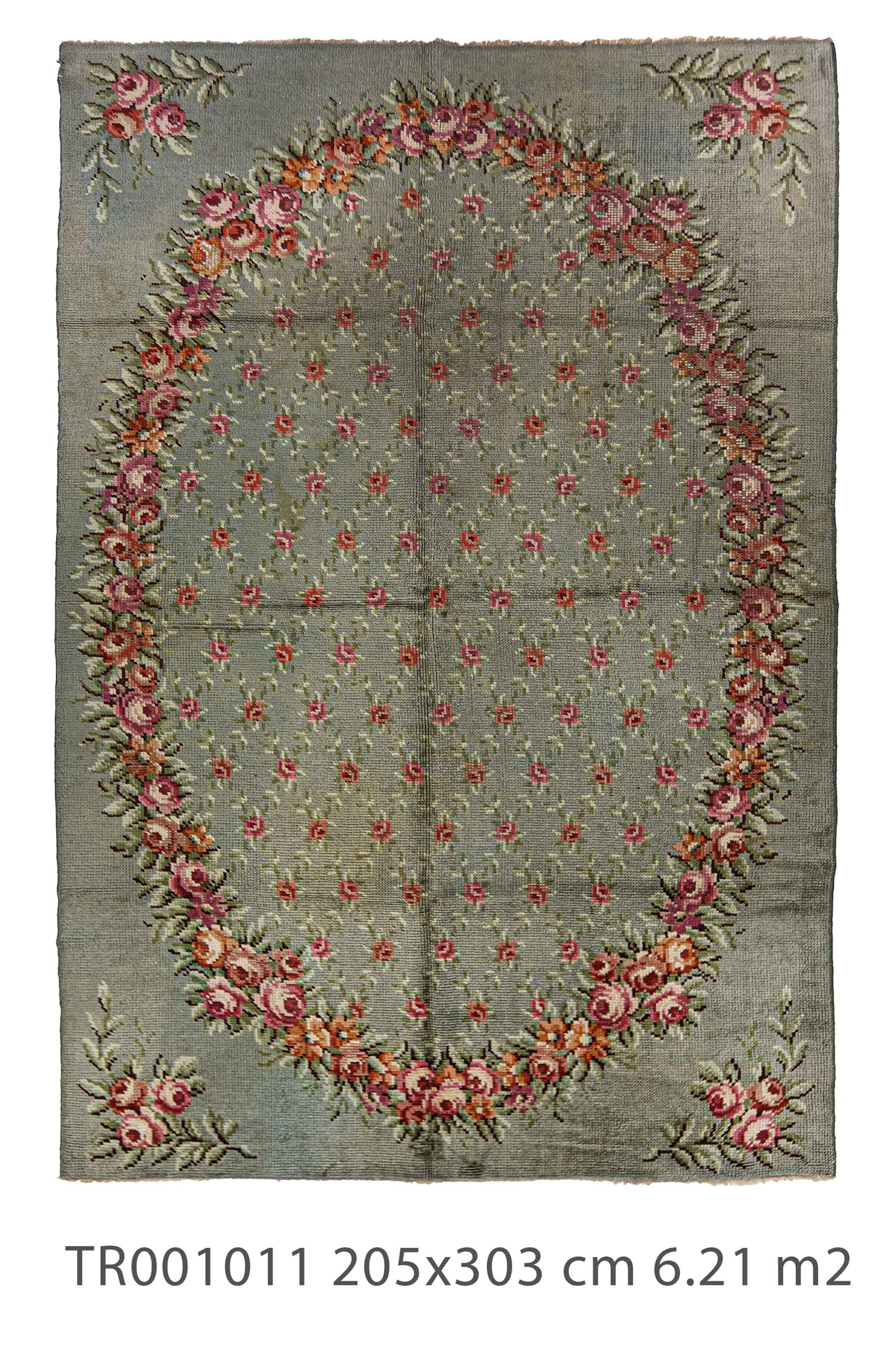 antique green rug with oval rose frame