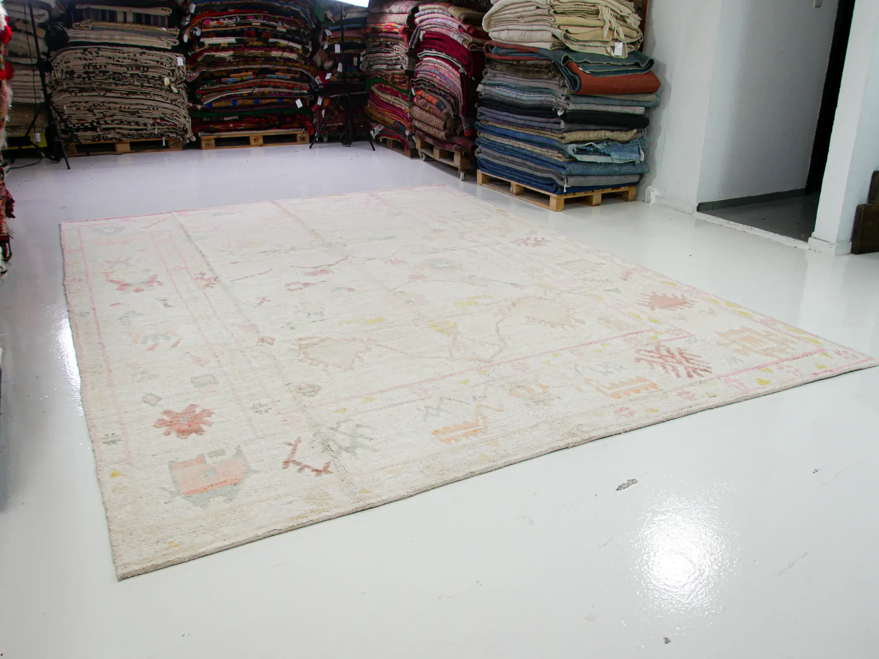 Off white tribal patterns pink blue yellow shades wool pompom rug