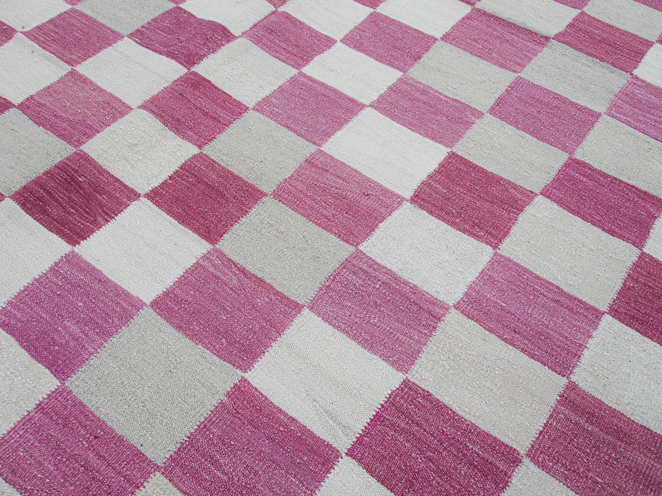 pink white checkered kilim rug