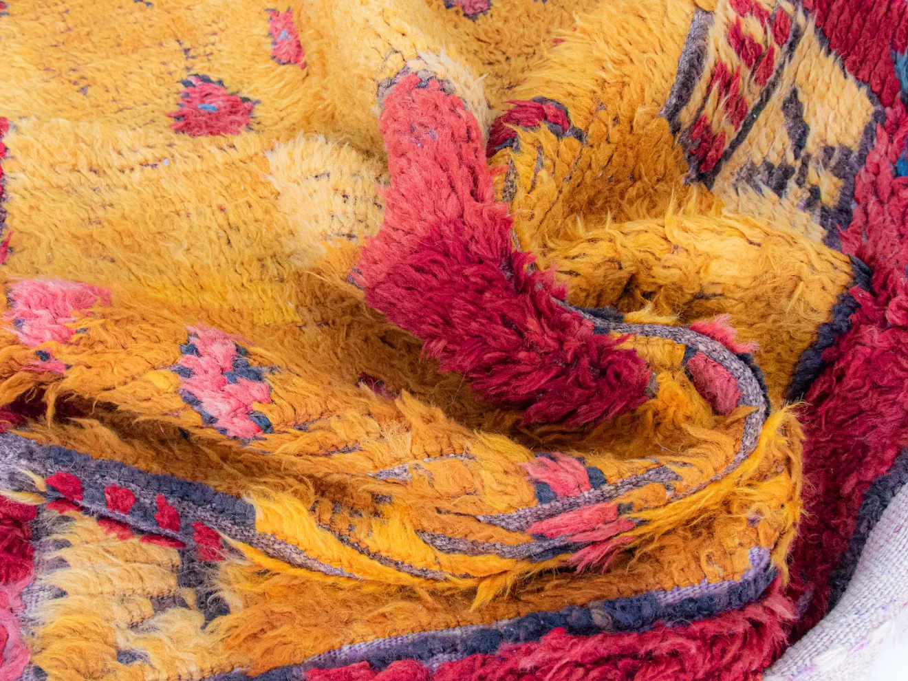 antique tulu rug, red framed with archaic tribal patterns, warm yellow color