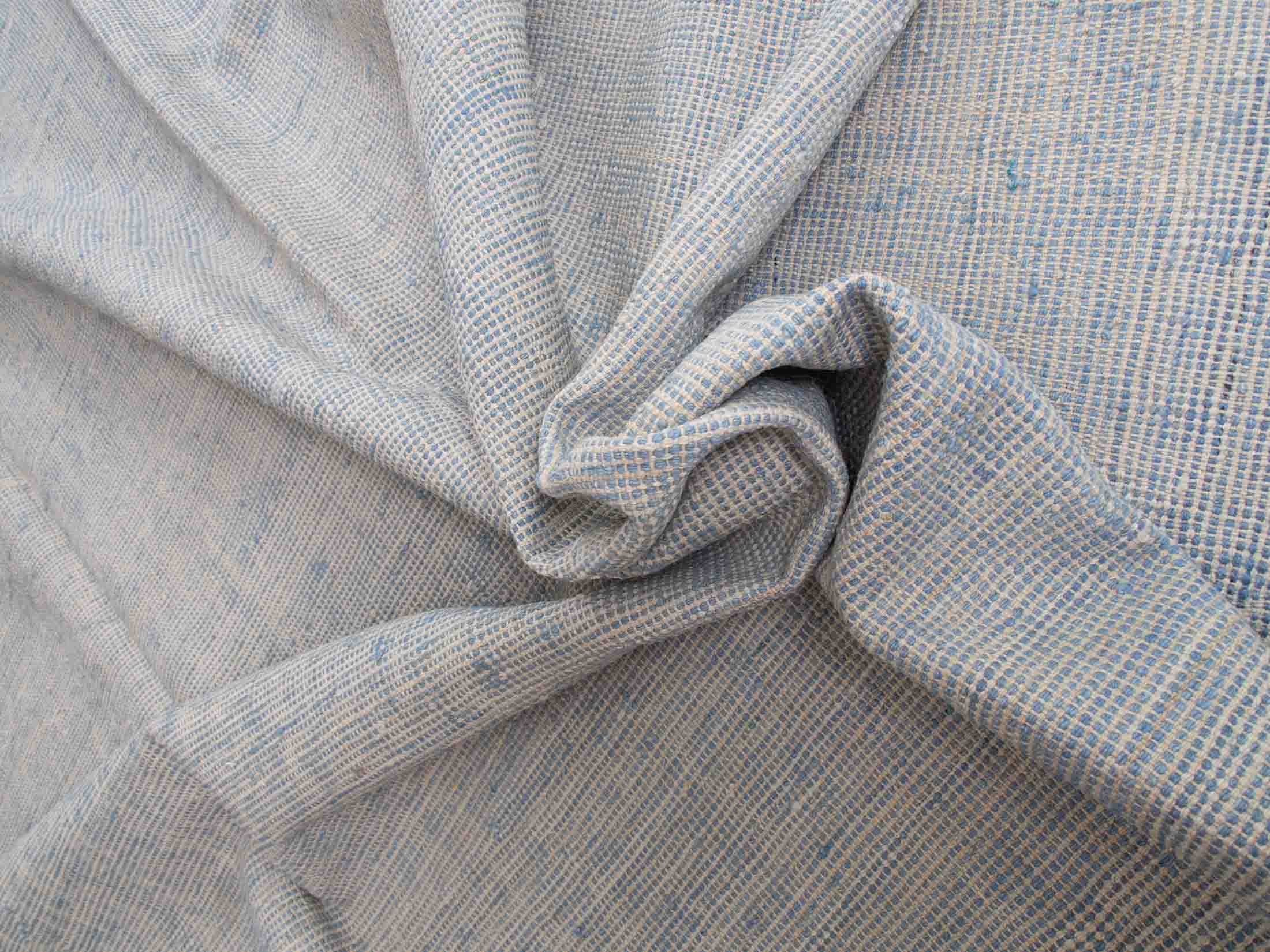 tight, intricate weave with subtle variations in color, including shades of grey and hints of blue