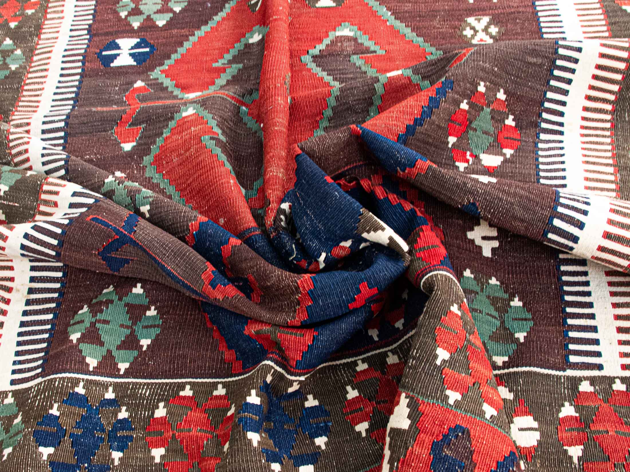Antique Central Anatolian Konya - Obruk kilim. This hand-woven wool masterpiece, from 1900's, boasts a beautiful brown base adorned with pastel green, terra cota red, and navy blue archaic patterns, all created using authentic root dyes.